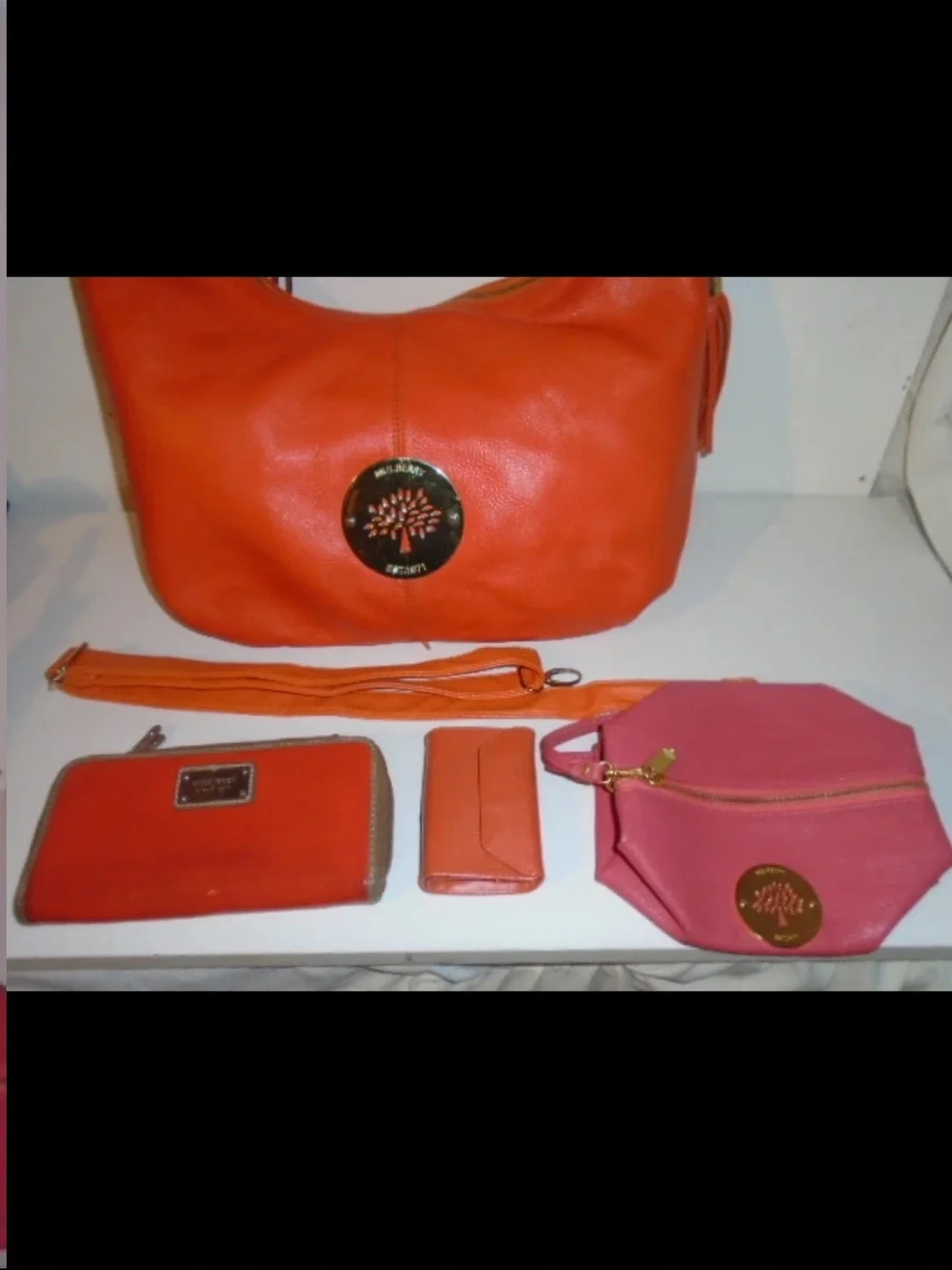 Mulberry Orange Leather Hobo Bag with Tassels and Gold Emblem